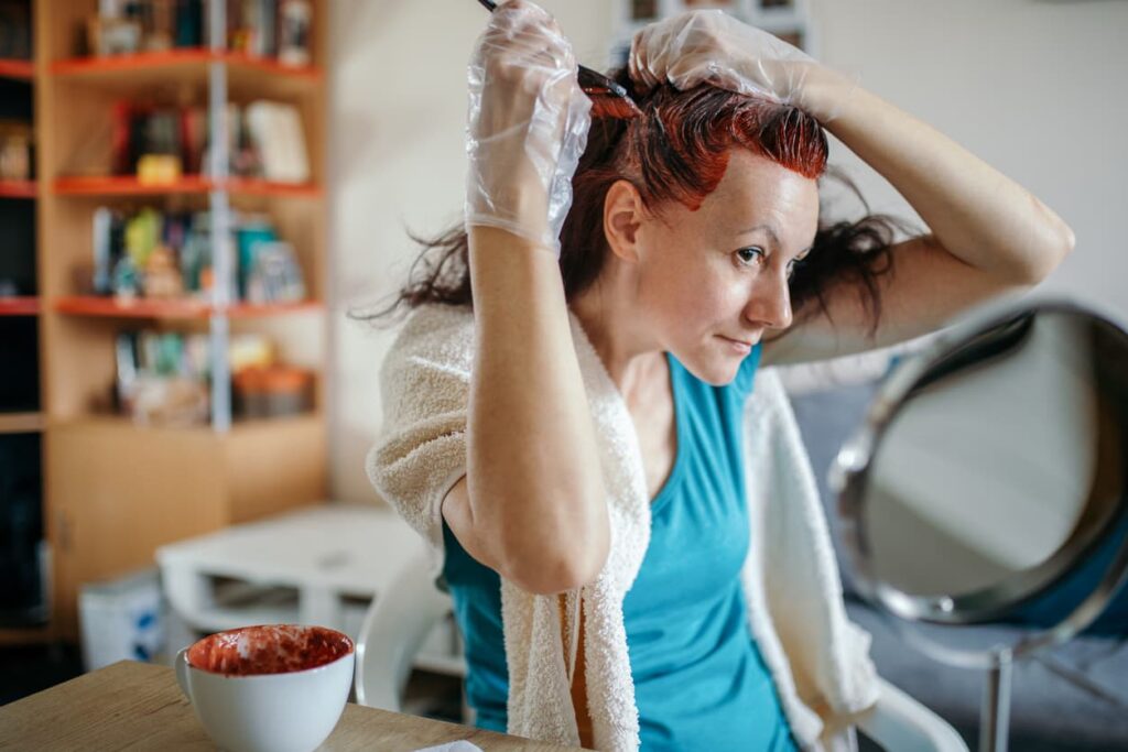 Tintura para cabelos, mulher ruiva tingindo cabelos em casa